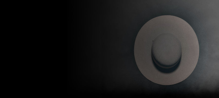 Wide-brimmed felt hat in soft light on a dark background, Italian handmade accessory