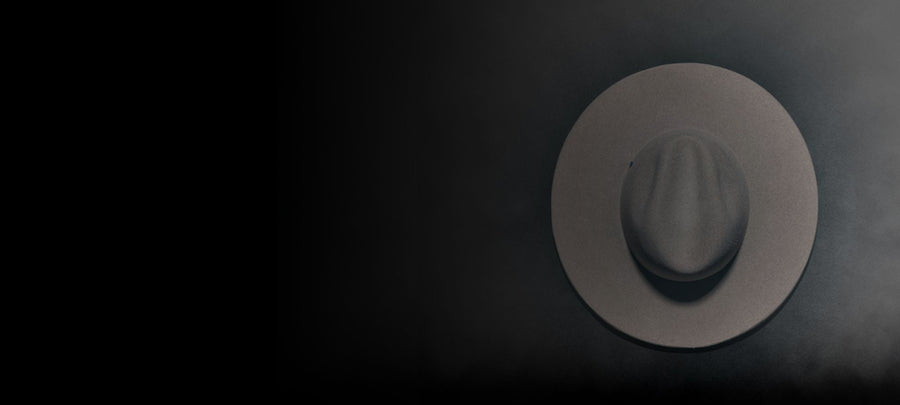 Wide brim felt hat in neutral color on dark gradient background, handmade Italian hat