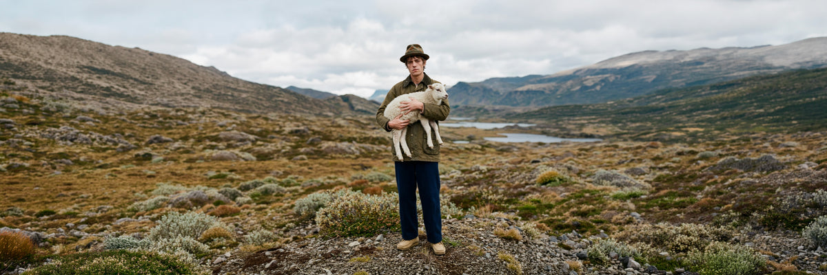 Man wearing a HOBO RAINMAKER hat in a wide highland valley